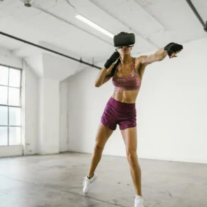 A woman engaging in a workout session using a VR headset indoors, promoting fitness and technology synergy.