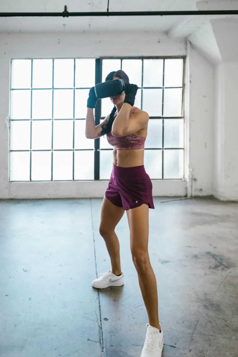 A woman exercising indoors with VR headset, embracing virtual reality fitness technology.